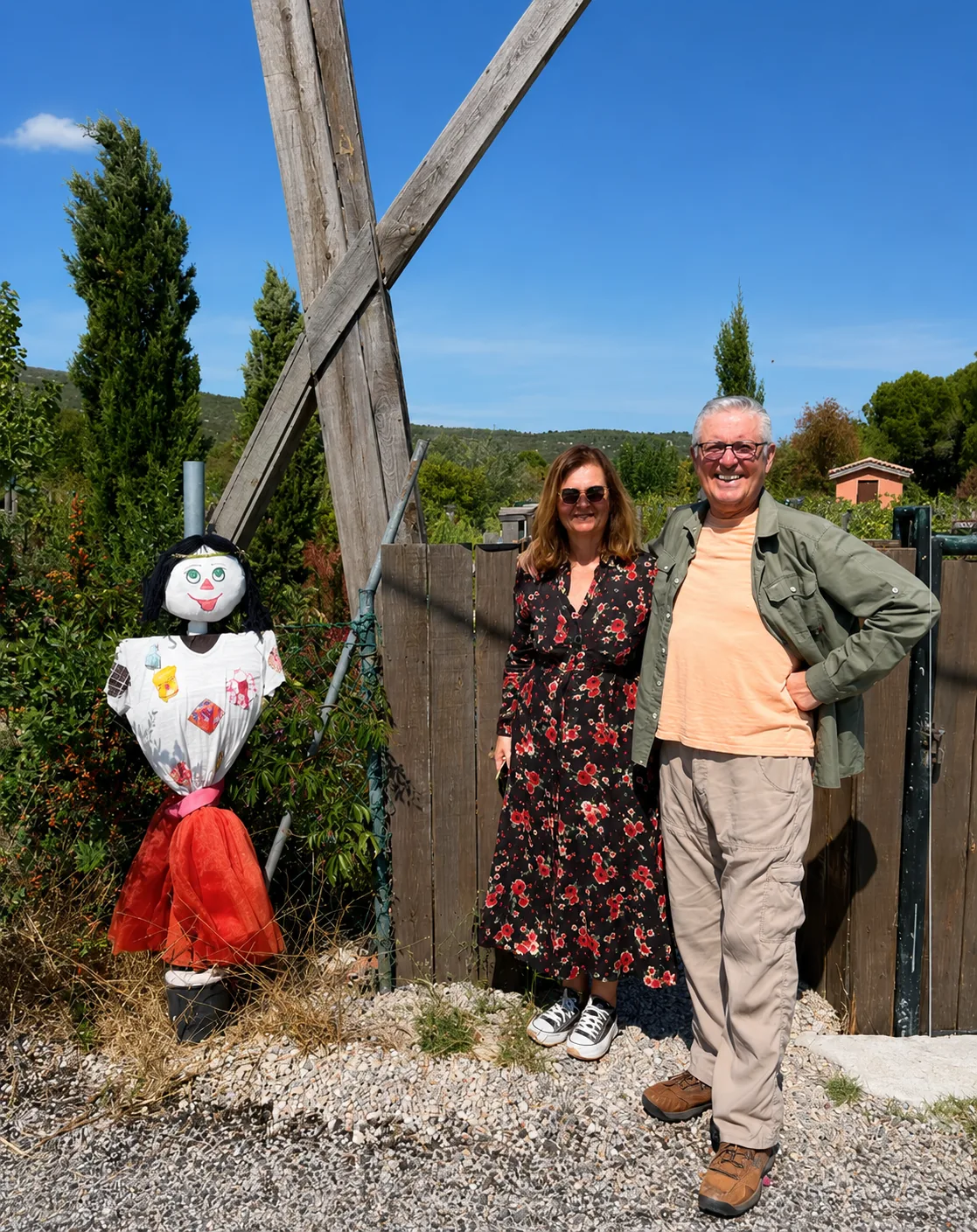 Two visitors standing beside a windmill at ION Village